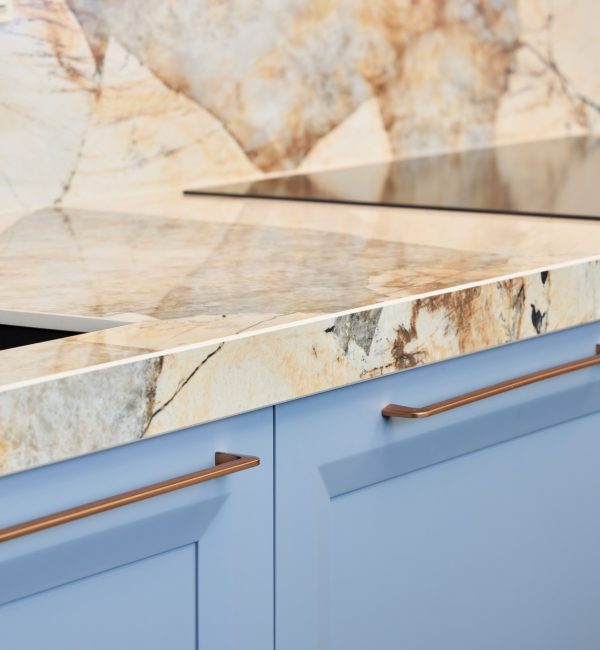 An Elegant Modern Kitchen featuring a stunning Marble Countertop and stylish Blue Cabinets