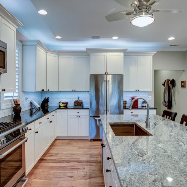 Beautiful luxury kitchen with quartz and granite countertops and white cabinets.