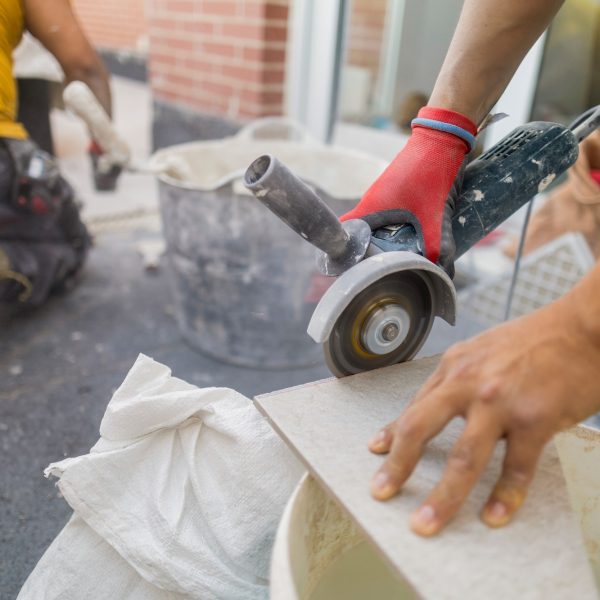 workers tiling house cutting floor tiles terrace